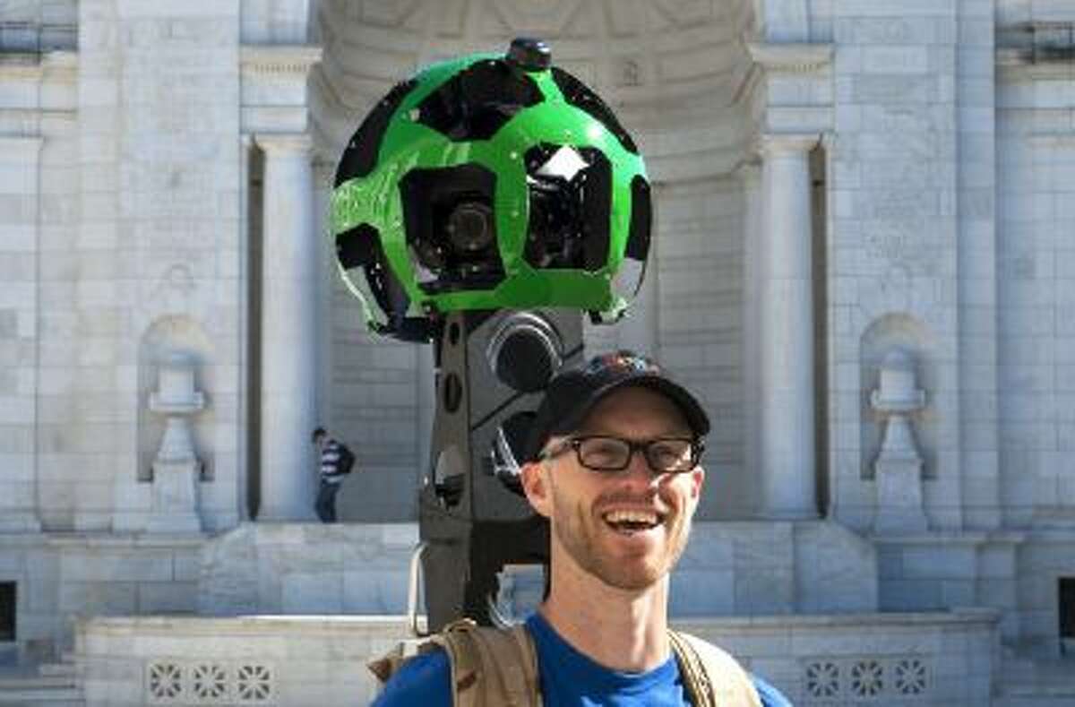 Patrick Fennie pauses for a photograph as he captures the scene at Memorial Amphitheater at Arlington National Cemetery in Virginia for Google Maps Street View on Sunday Oct. 20, 2013. The images will be stitched together and released in May, allowing people to virtually visit the cemetery on their computers.