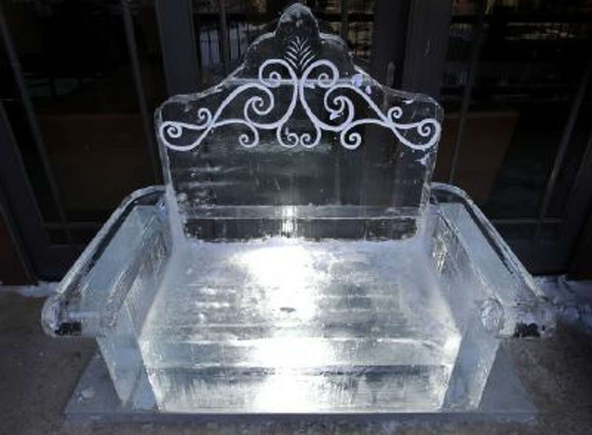 The lounge is adorned with sculpted ice furniture, like this chair.