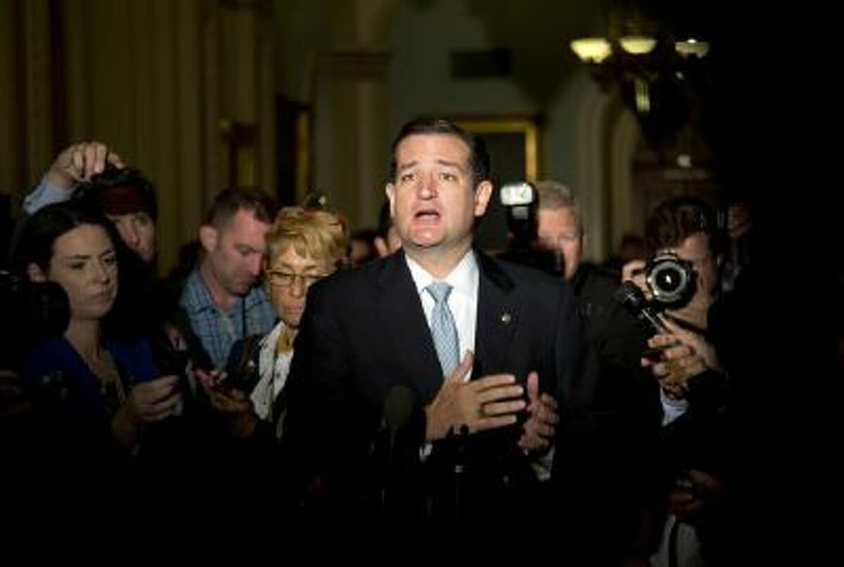 In this Oct. 16, 2013, file photo Sen. Ted Cruz, R-Texas, talks to reporters on Capitol Hill in Washington after House leaders reached a last-minute agreement to avert a threatened Treasury default and reopen the government after a partial, 16-day shutdown.