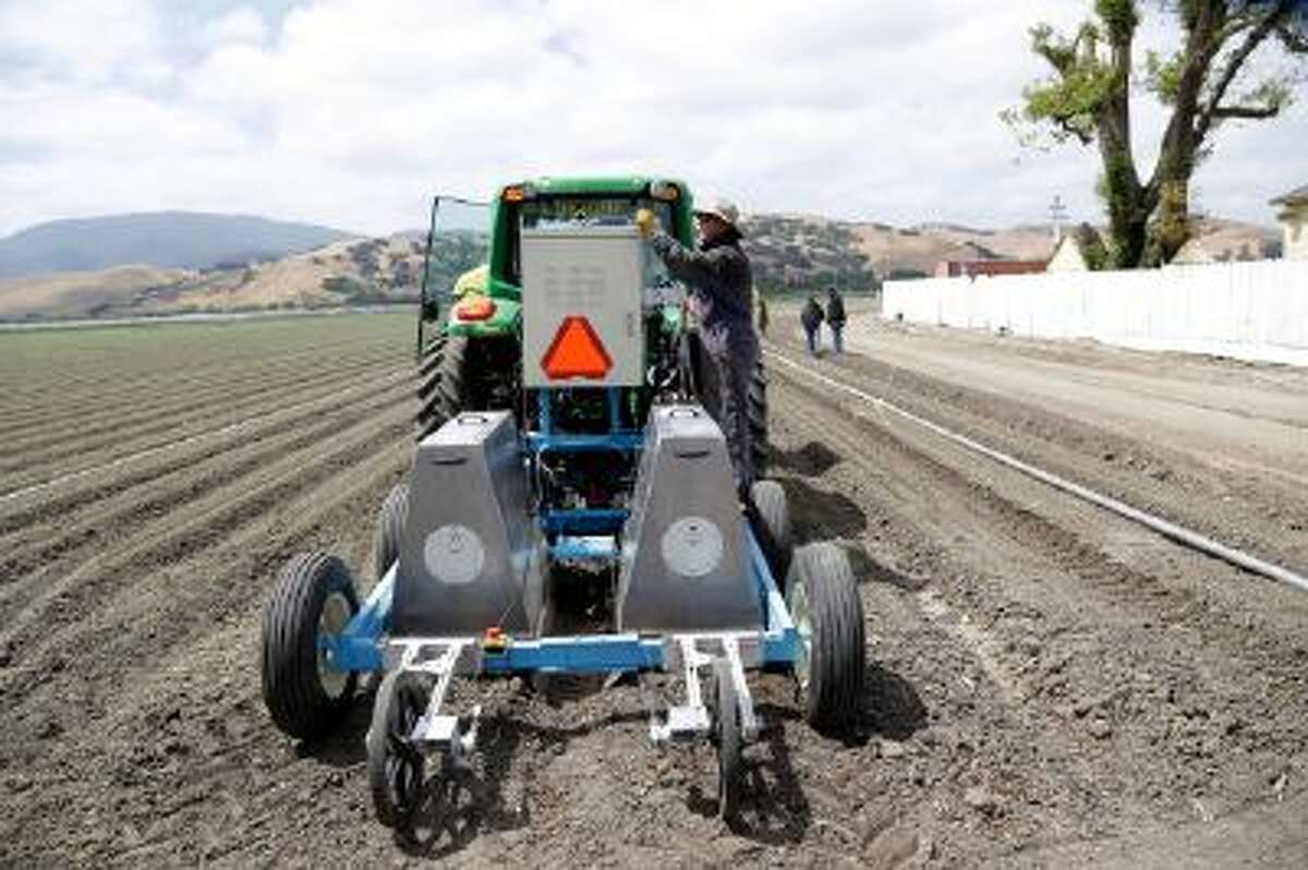 Field operations manager Matthew Rossow tests the lettuce bot in Salinas, Calif. Entrepreneurs with the Silicon Valley company Blue River Technology are testing the Lettuce Bot, a boxy robotic machine that can thin fields of lettuce, a job that now requires detailed hand work by 20 farm workers.
