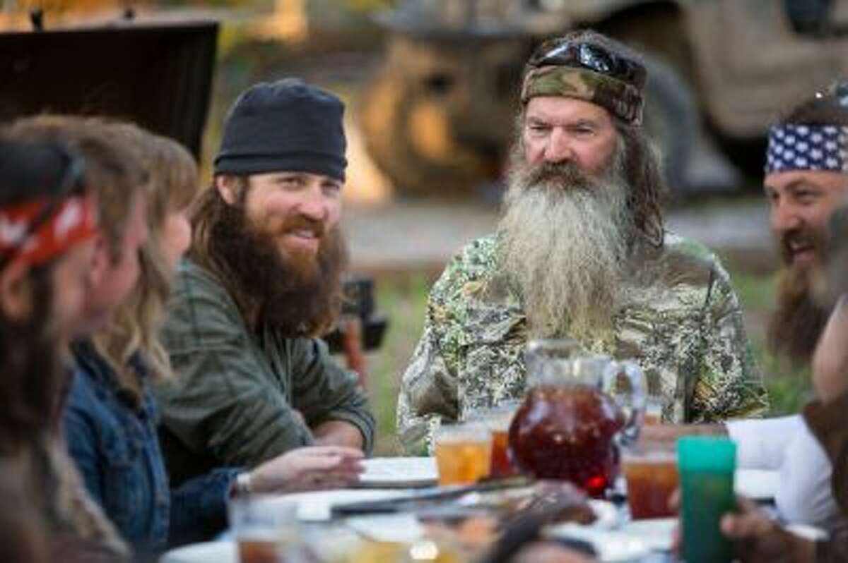 This undated image released by A&E shows Phil Robertson, flanked by his sons Jase Robertson, left, and Willie Robertson from the popular series "Duck Dynasty."