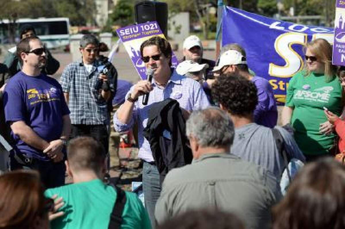 Pete Castelli, of SEIU 1021 speaks at a noontime rally outside of the Lake Merritt BART station in Oakland, Calif., on Friday, Oct. 18, 2013.