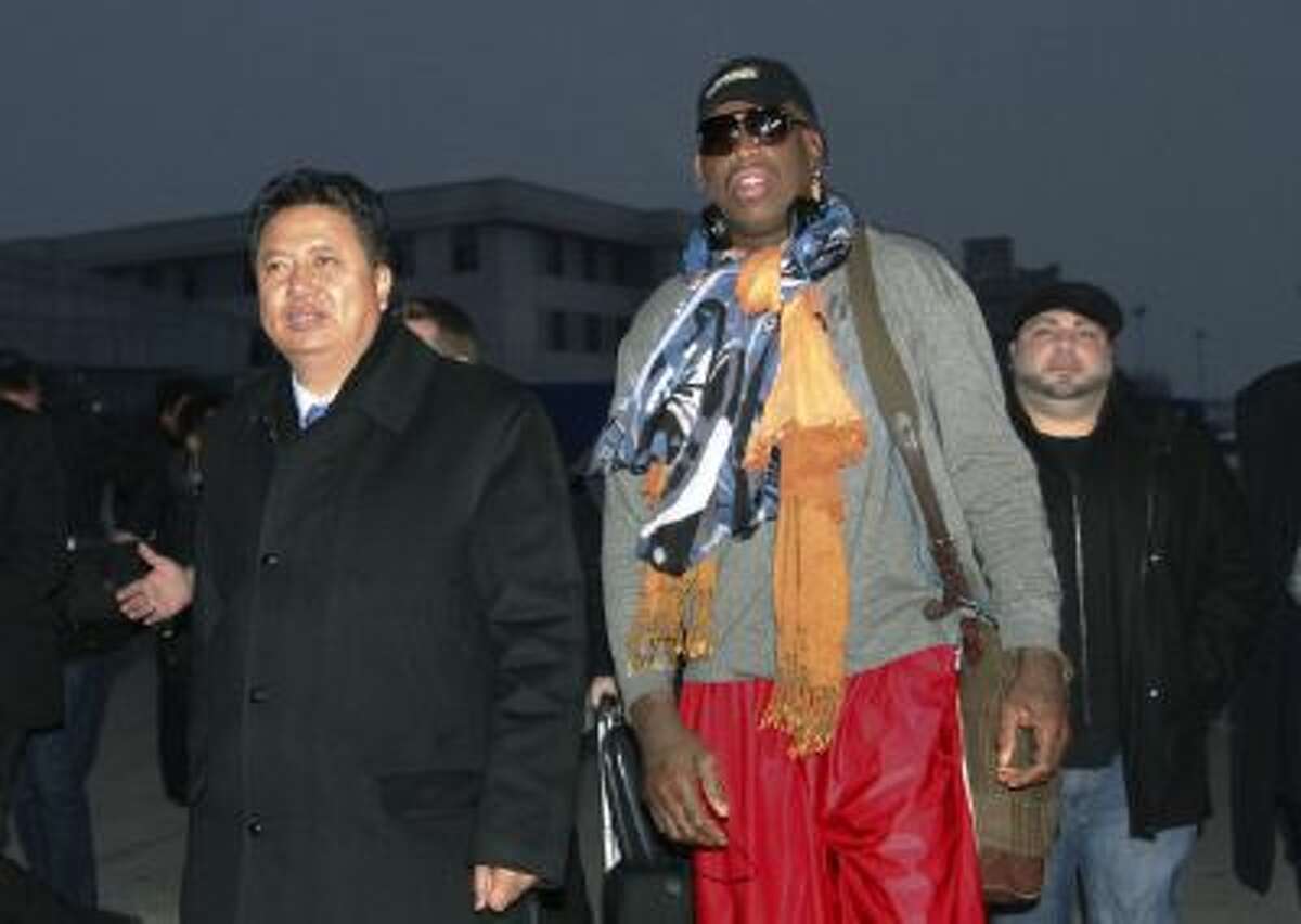 Dennis Rodman walks with Vice Minister of North Korea's Sports Ministry, Son Kwang Ho, as Rodman arrives at the international airport in Pyongyang, North Korea.