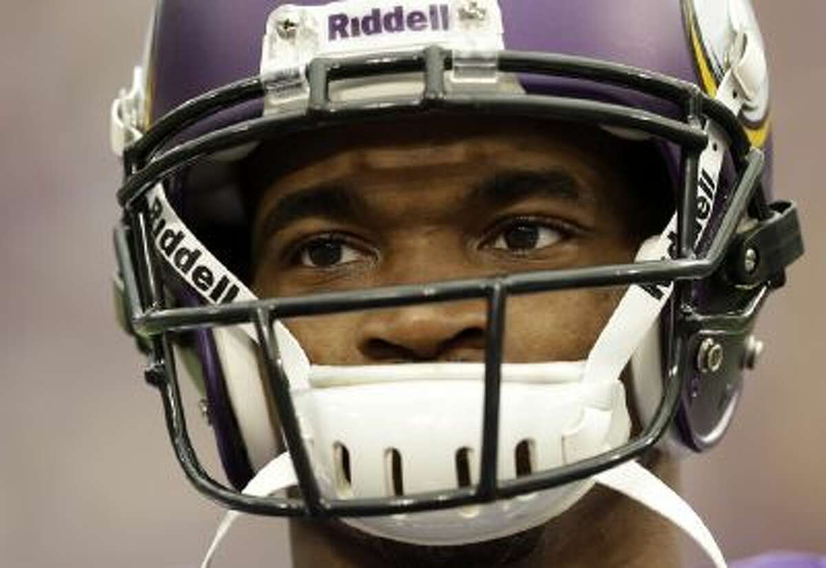 Minnesota Vikings running back Adrian Peterson pauses during introductions before an NFL football game against the Carolina Panthers in Minneapolis, Sunday, Oct. 13, 2013. One of the star running back's sons, a 2-year-old in South Dakota, died Friday after an alleged attack in a child abuse case.