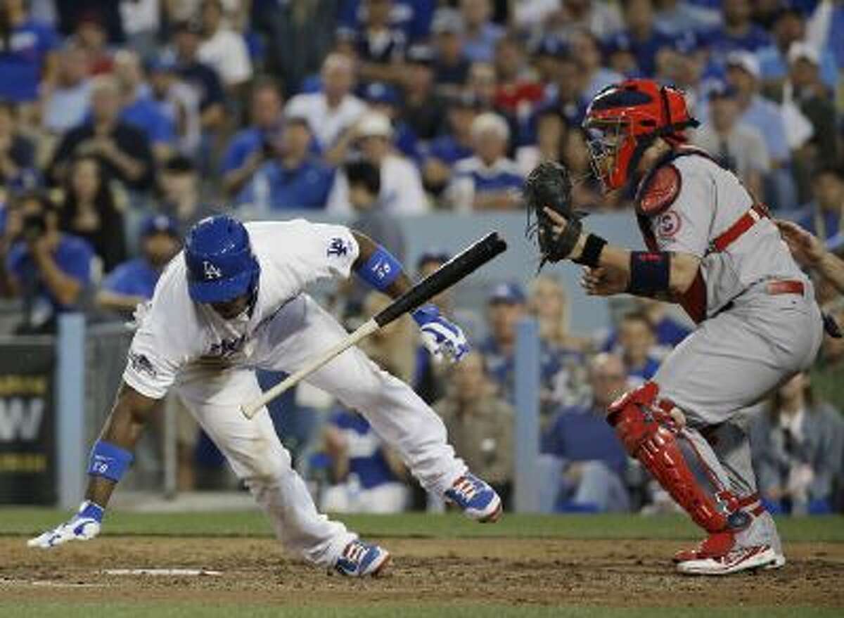 Yasiel Puig avoids a fastball high and inside thrown by St. Louis Cardinals pitcher Lance Lynn in Game 4 of the NLDS.