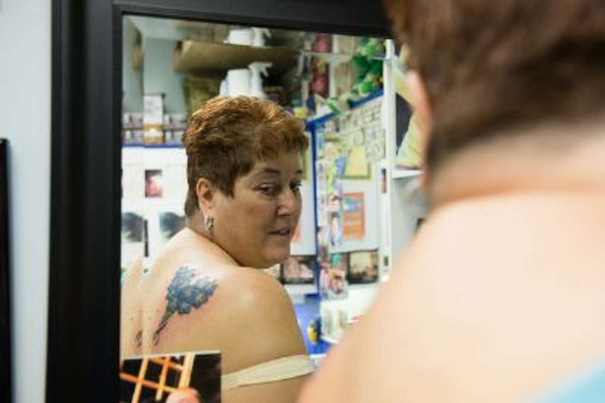 Darlene Nash, 57, went to Dragon Moon Tattoo Studio on Sept. 13, 2013 in Glen Burnie, Md. to get a tattoo to honor her sister and another featuring her grandchildren.