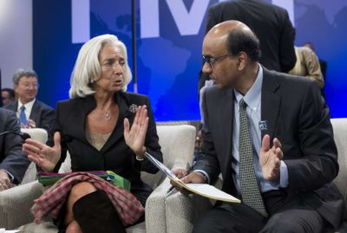 International Monetary Fund (IMF) Managing Director Christine Lagarde, speaks with Singaporean Minister for Finance Tharman Shanmugaratnam, who is also the chairman of the IMFC, before a meeting of the IMFC, during the World Bank/IMF Annual Meetings at IMF headquarters, Saturday, Oct. 12, 2013, in Washington.