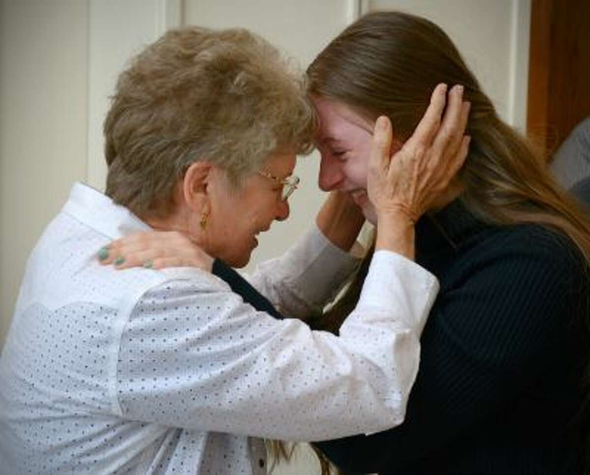 Tibby Middleton, left, shares an emotional moment with granddaughter Madison Middleton on Saturday at the Unitarian Universalist Congregation of Frederick, Md. Illustrates MARRIAGE (category a), by Michael S. Rosenwald (c) 2013, The Washington Post. Moved Saturdayday, Oct. 12, 2013. (MUST CREDIT: Washington Post photo by Bill OLeary)
