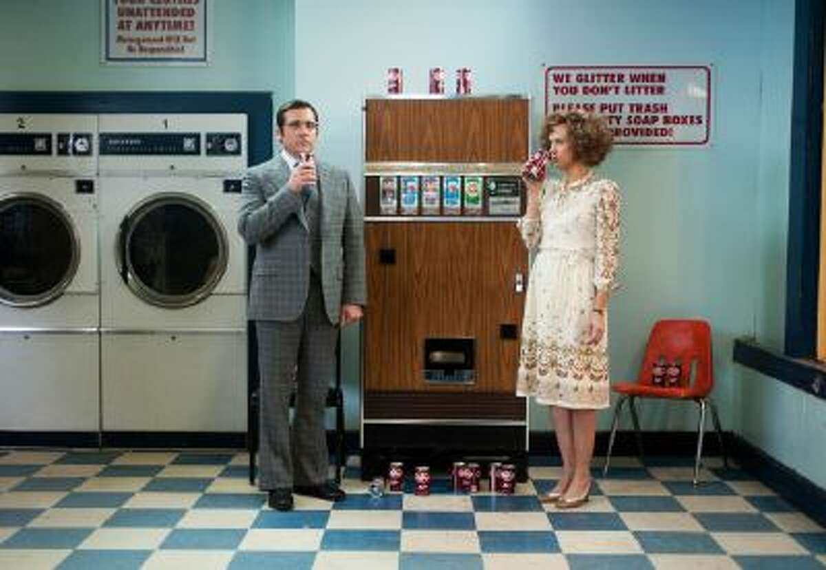 This photo provided by Paramount Pictures shows Steve Carell, left, as Brick Tamland and Kristen Wiig as Chani Lastnamé, in a scene from the film, "Anchorman 2: The Legend Continues." Paramount Pictures releases the film in the U.S. on Dec. 18, 2013.