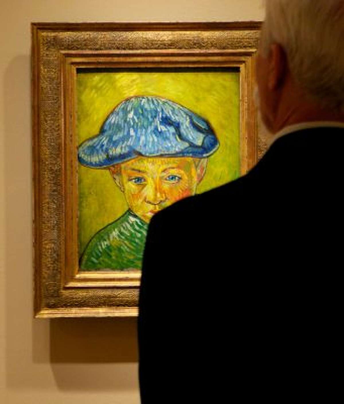 In this Oct. 8, 2013 photo, a visitor studies Vincent van Gogh's "Portrait of Camille Roulin," on display at The Phillips Collection in Washington. (AP Photo/Molly Riley)