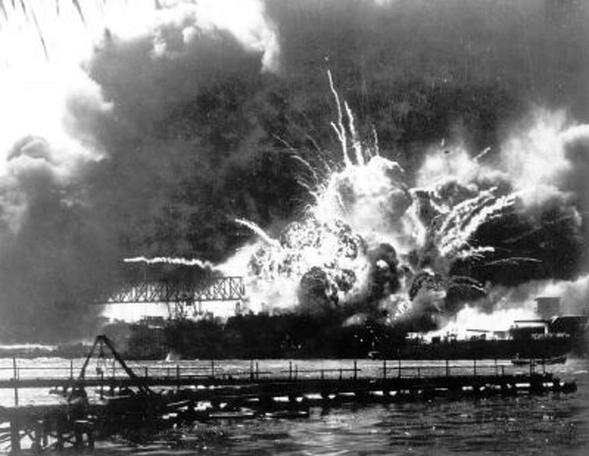 In this Dec. 7, 1941 file photo, the destroyer USS Shaw explodes after being hit by bombs during the Japanese surprise attack on Pearl Harbor, Hawaii.