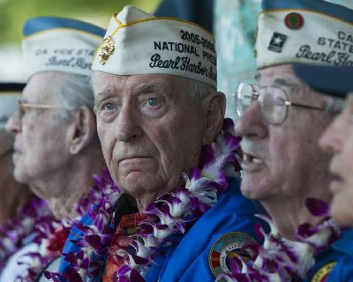 Pearl Harbor survivor Mal Middlesworth, center, sits with other Pearl Harbor survivors before the start of ceremony commemorating the 72nd anniversary of the attack on Pearl Harbor, Saturday, Dec. 7, 2013, in Honolulu.
