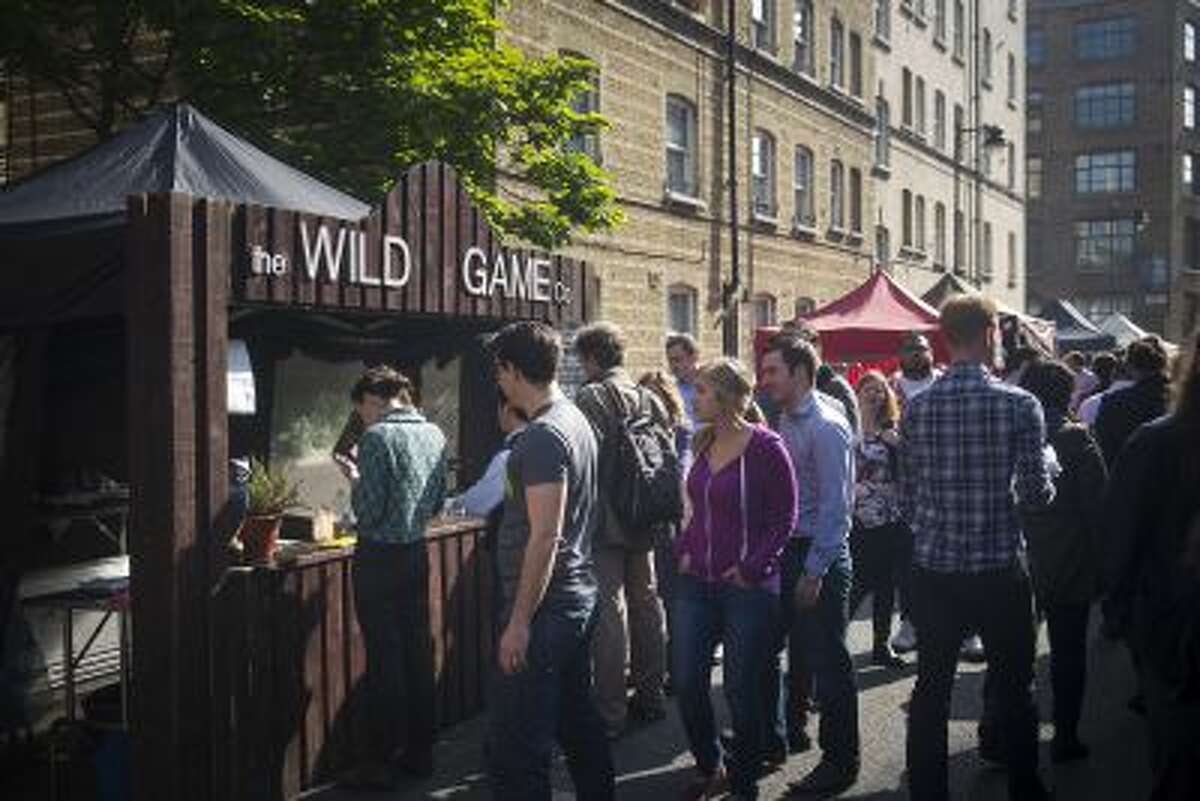 Patrons line up at the Wild Game Co. stall on Whitecross Street in London; Wild Game won the 2012 Young British Foodies street food award.