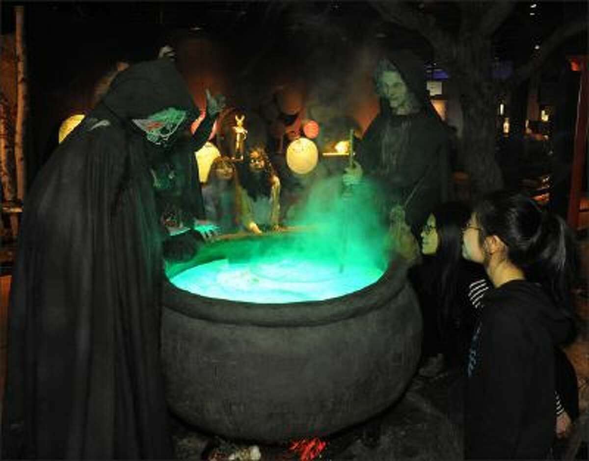 Children observe a witch-brewing installation from Macbeth at the American Museum of Natural History in New York, U.S., in this handout photo taken on Nov. 8, 2013. Other exhibits at the museum include the role of poison in history, literature, myth and medicine.