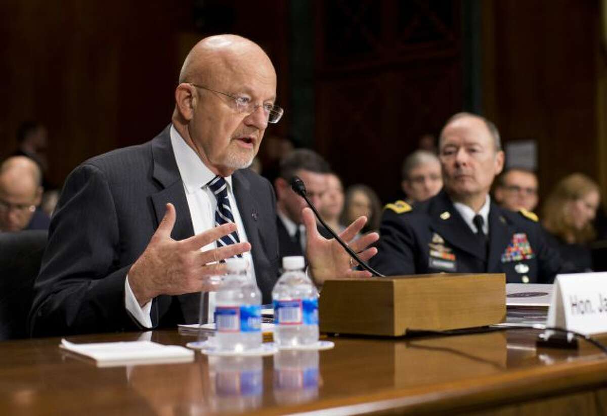 National Intelligence Director James Clapper, left, accompanied by National Security Agency Director Gen. Keith Alexander, testifies on Capitol Hill in Washington, Wednesday, Oct. 2, 2013, before the Senate Judiciary Committee oversight hearing on the Foreign Intelligence Surveillance Act. U.S. intelligence officials say the government shutdown is seriously damaging the intelligence community's ability to guard against threats. (AP Photo/ Evan Vucci)