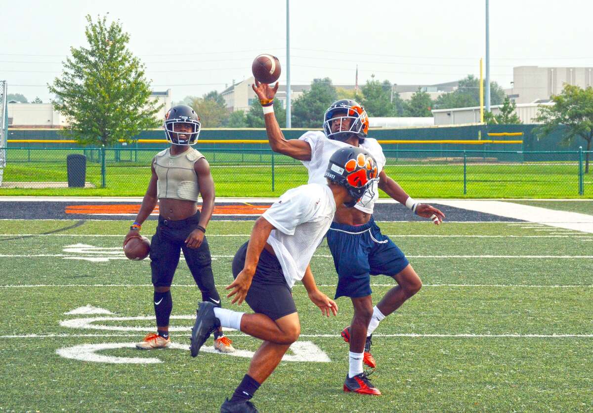 The Edwardsville Tigers run through a wide receiver-defensive back drill during practice on Monday at the District 7 Sports Complex.