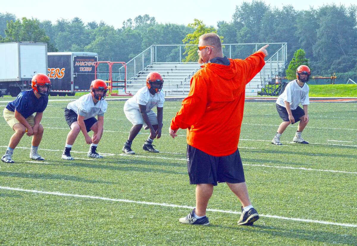 Edwardsville defensive coordinator Kelsey Pickering shouts out instruction during a drill.