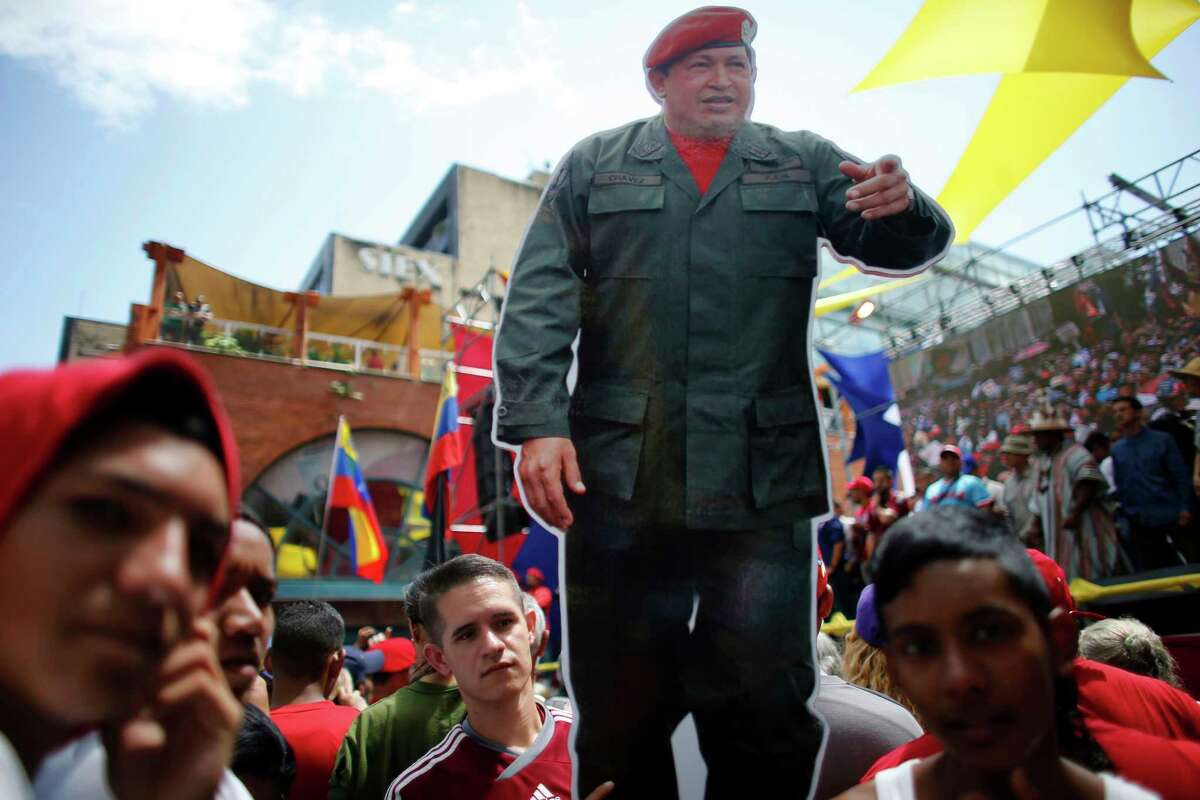 A cutout of Venezuela's late President Hugo Chavez stands out among supporters during a rally backing the the new Constitutional Assembly outside the National Assembly building in Caracas, Venezuela, Monday, Aug. 7, 2017. Pro- and anti-government factions dug themselves further into their trenches Monday amid Venezuela's deepening political crisis, with each side staking a claim to the powers granted them by dueling national assemblies. (AP Photo/Ariana Cubillos) ORG XMIT: XFLL105