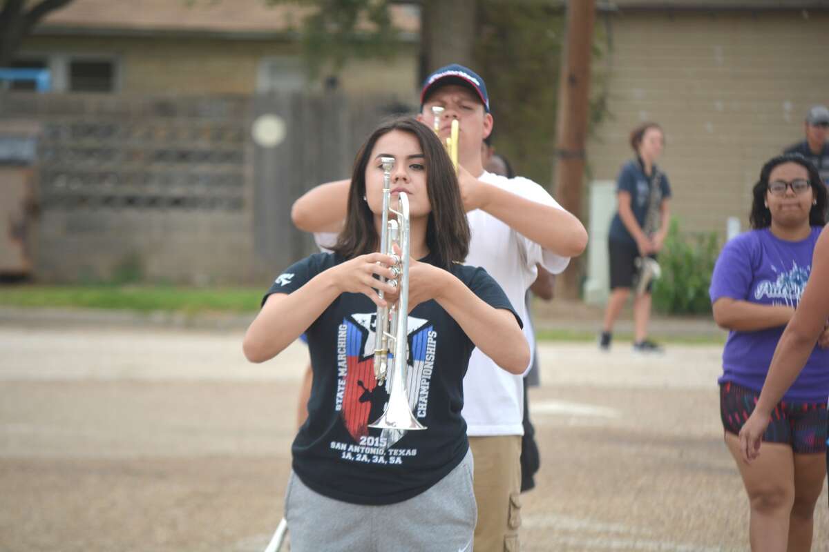 Allison Soliz holds her trumpet at the ready as she and other trumpet and cornet players in the Plainview High Powerhouse of the Plains Band goes through morning drills Tuesday. The band has been rehearsing daily to learn the intricate moves and tunes that make up this year’s halftime show, titled “Twisted.” The same show will be used for UIL marching contest Oct. 21 when the group will seek its 80th consecutive First Division rating. That remarkable streak began in 1937 under the leadership of bandmaster R.C. “Chief” Davidson. The PHS Band is now directed by Anthony Gonzalez.