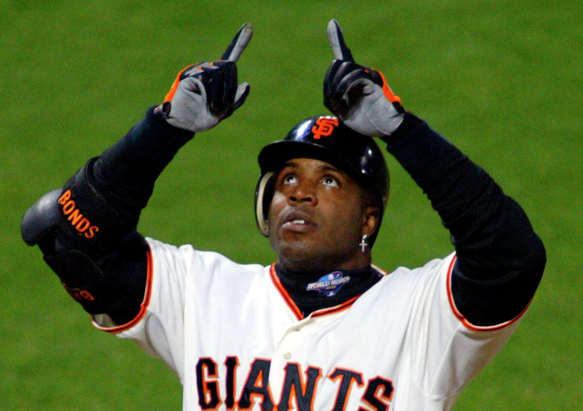 San Francisco Giants' Barry Bonds celebrates his two-run homer off Anaheim Angels pitcher Ramon Ortiz in the fifth inning of Game 3 of the World Series in San Francisco Tuesday, Oct. 22, 2002. (AP Photo/Eric Risberg)