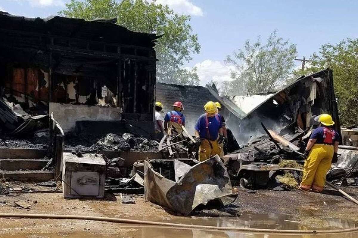 Members of the Olton Volunteer Fire Department begin mopping up at a July 29 fire that destroyed the home of Jose and Marquez. Her father, Uvaldo Rivera, 78, was rescued from the burning house by a neighbor, Pablo Peralez.