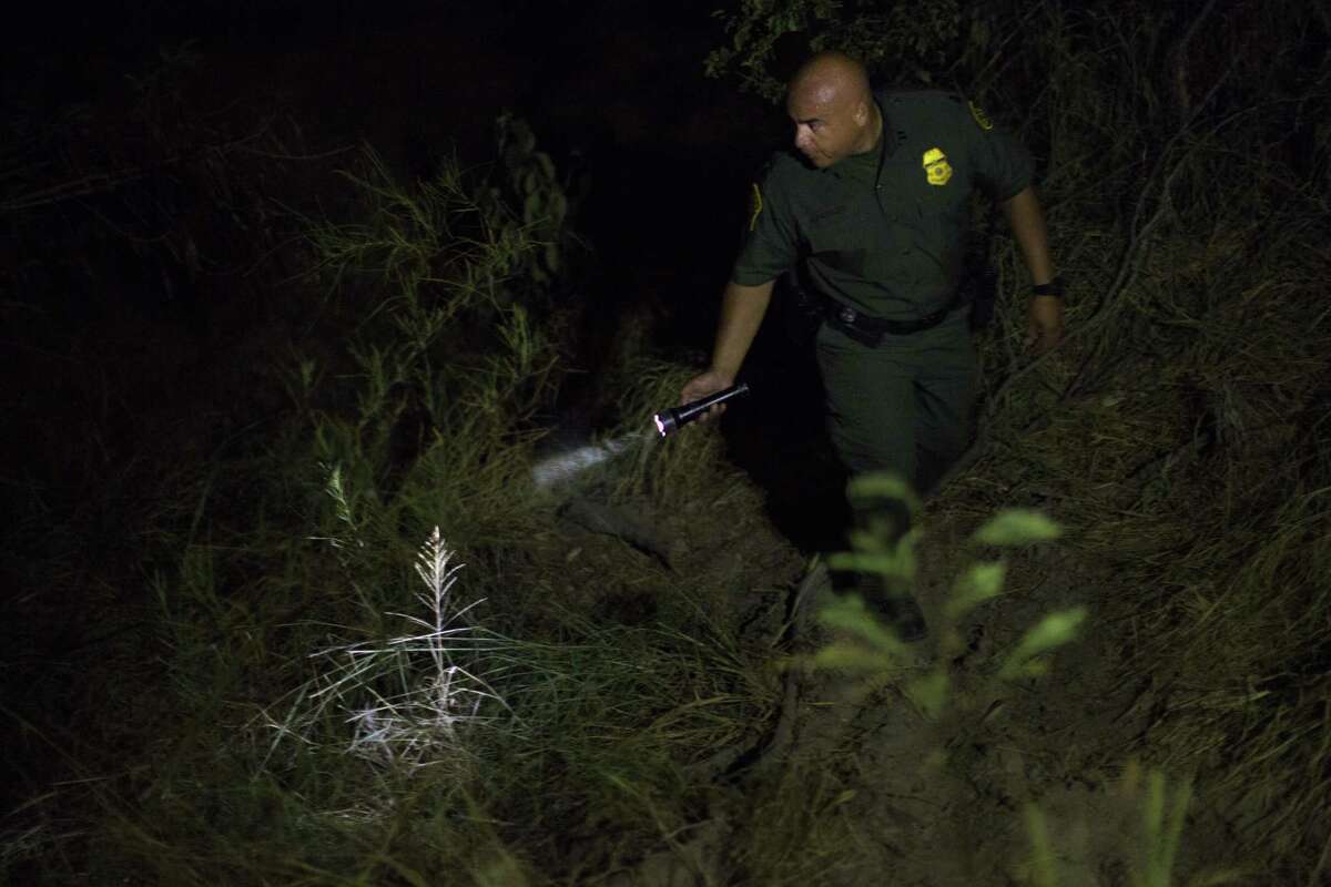 Supervisor Border Patrol Agent Jose Luis Perales walks in the dark searching for individuals that might have crossed the United States southern border unlawfully carrying narcotics. Tuesday, July 21, 2015, in Roma. ( Marie D. De Jesus / Houston Chronicle )