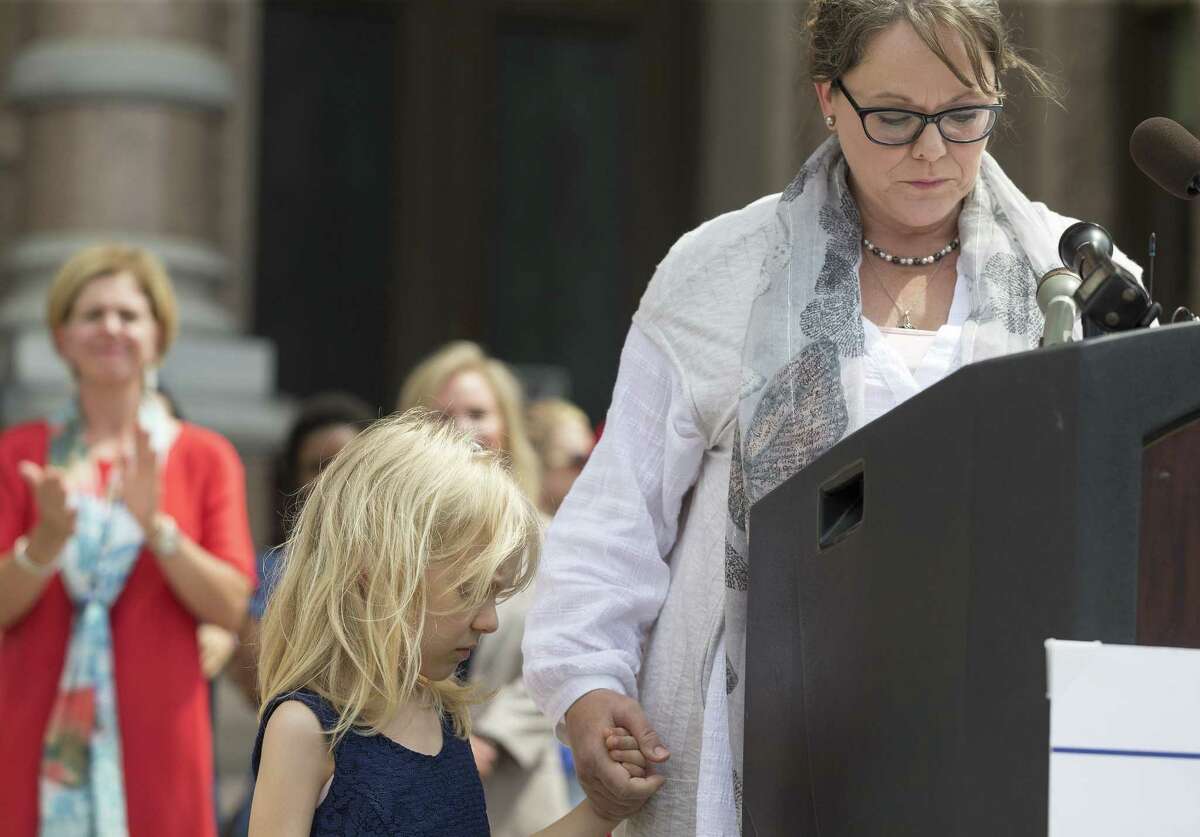 Kai Shappley, 5, attends stands with her mother Kimberly Shappley during "Keep Texas Open for Business" event at the Texas Capitol in Austin, Tuesday, Aug. 8, 2017. Those in attendance urged the Texas Legislator to reject the bathroom bill. (Stephen Spillman / for Express-News)