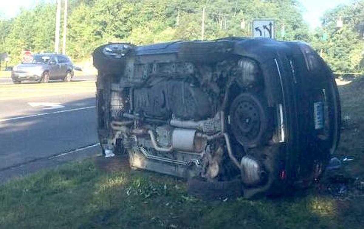 A car lays on its side on Grist Mill Road after it crashed Aug. 9 near Route 7 in Norwalk following a high-sped pursuit from Westport.