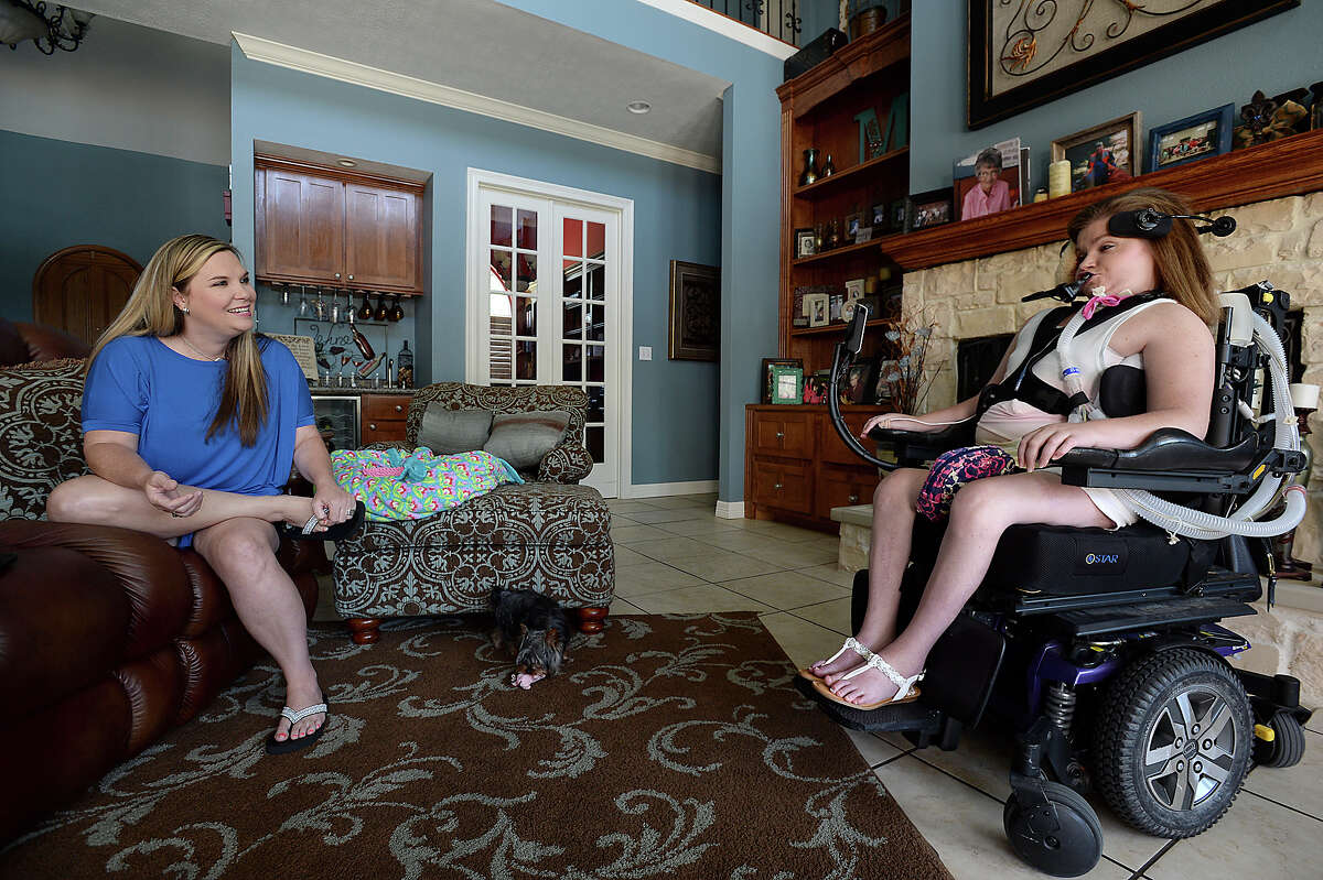 Melissa McMillan and daughter Lauren McMillan talk in their Lumberton home about their experiences earning their bachelor's degrees together at Lamar University. The pair will graduate together at the December commencement. Melissa decided to enroll and earn her college degree after spending time assisting Lauren in her college classes. Lauren has been paralyzed since a car accident in 2002, when their car was struck on the way to school by a driver who fell asleep at the wheel. Photo taken Tuesday, August 1, 2017 Kim Brent/The Enterprise