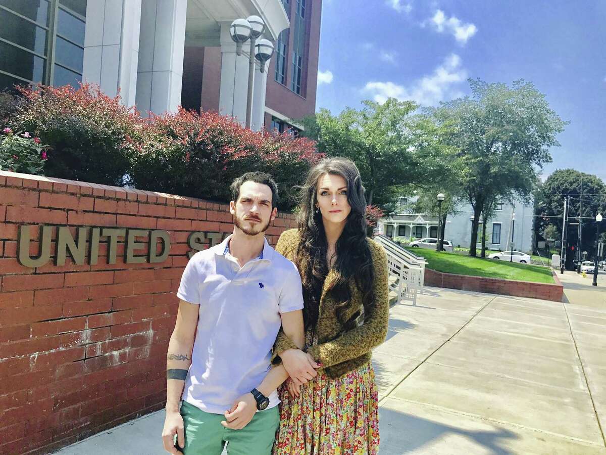 Dane Lane, left, and his transgender wife, Allegra Schawe-Lane, outside the federal courthouse in Covington, Ky. The couple is filing a lawsuit against Amazon, alleging that they endured sustained discrimination and harassment during a year as co-workers at an Amazon warehouse in Kentucky.