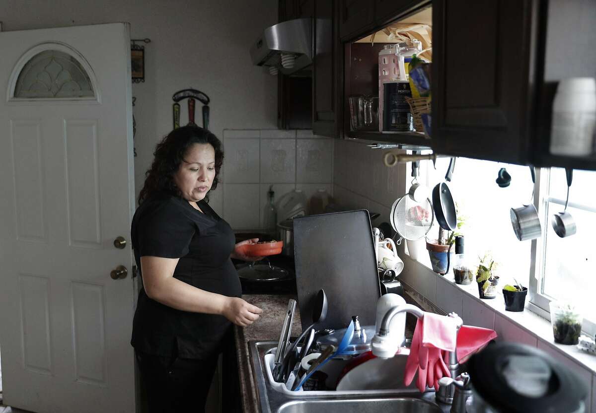Maria Mendoza Sanchez prepares her lunch before she leaves for work from her home in Oakland, Calif., on Tuesday, August 8, 2017. Mendoza Sanchez and her husband Eusebio are from Mexico, and the pair have four children -- three of whom are U.S. citizens. But the couple faces deportation next week.