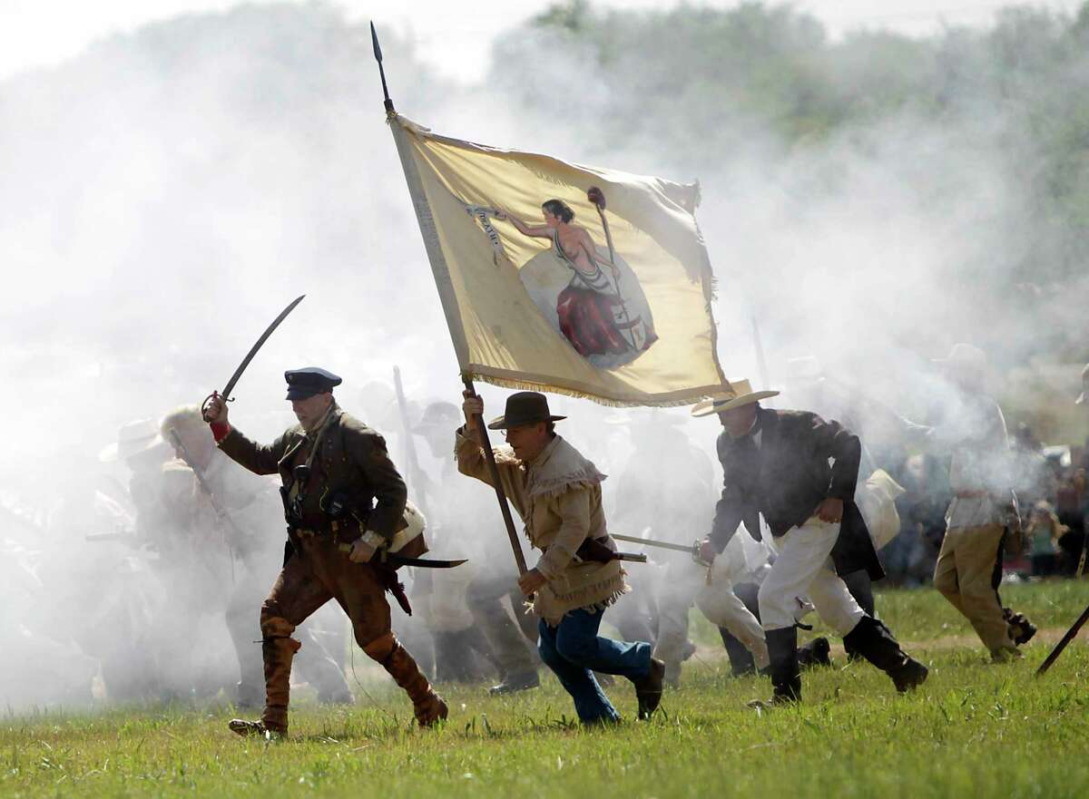 In this photo from April 16, 2011, the 175th anniversary of Texas' independence, re-enactors playing the parts of members of the Texian Army, charge toward the Mexican encampment during the Battle of San Jacinto on the grounds of the San Jacinto Battleground in Houston. ( Karen Warren / Houston Chronicle )