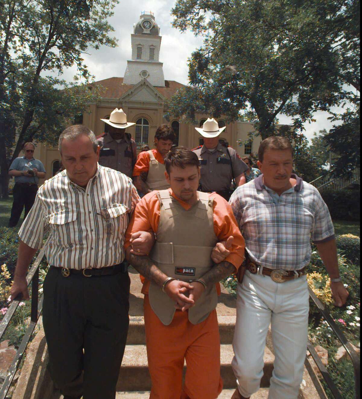 John William King, front, and Lawrence Russell Brewer are escorted from the Jasper County courthouse Tuesday, June 9, 1998, in Jasper, Texas. King, Brewer and Shawn Allen Berry are charged with first degree murder in the death of James Byrd Jr. Byrd's was tied to a truck and dragged to his death along a rural East Texas road. (AP Photo/David J. Phillip)
