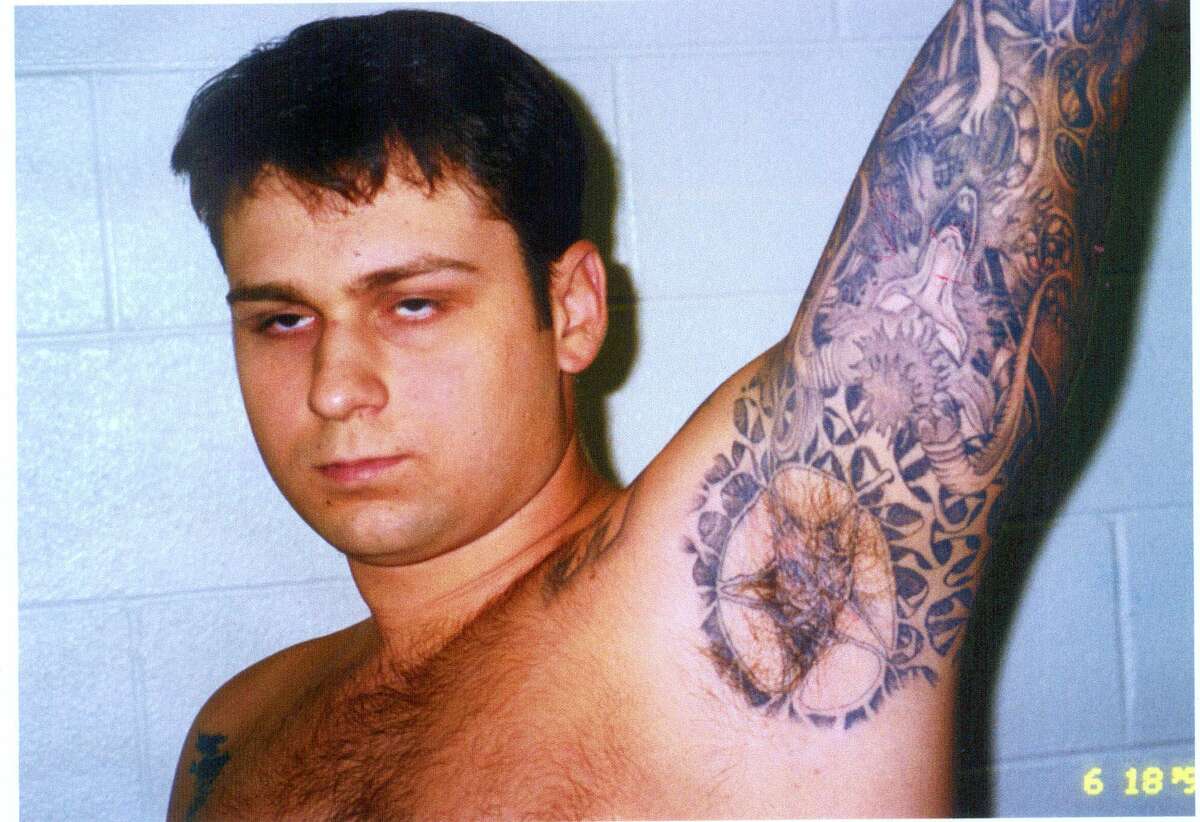 FILE - This photo of murder defendant John William King, showing some of his tattoos, was entered into evidence Wednesday, Feb. 17, 1999, in Jasper, Texas. King is one of three white men charged with capital murder in the dragging death of James Byrd Jr. (AP Photo/Jasper County District Attorney's Office, POOL)