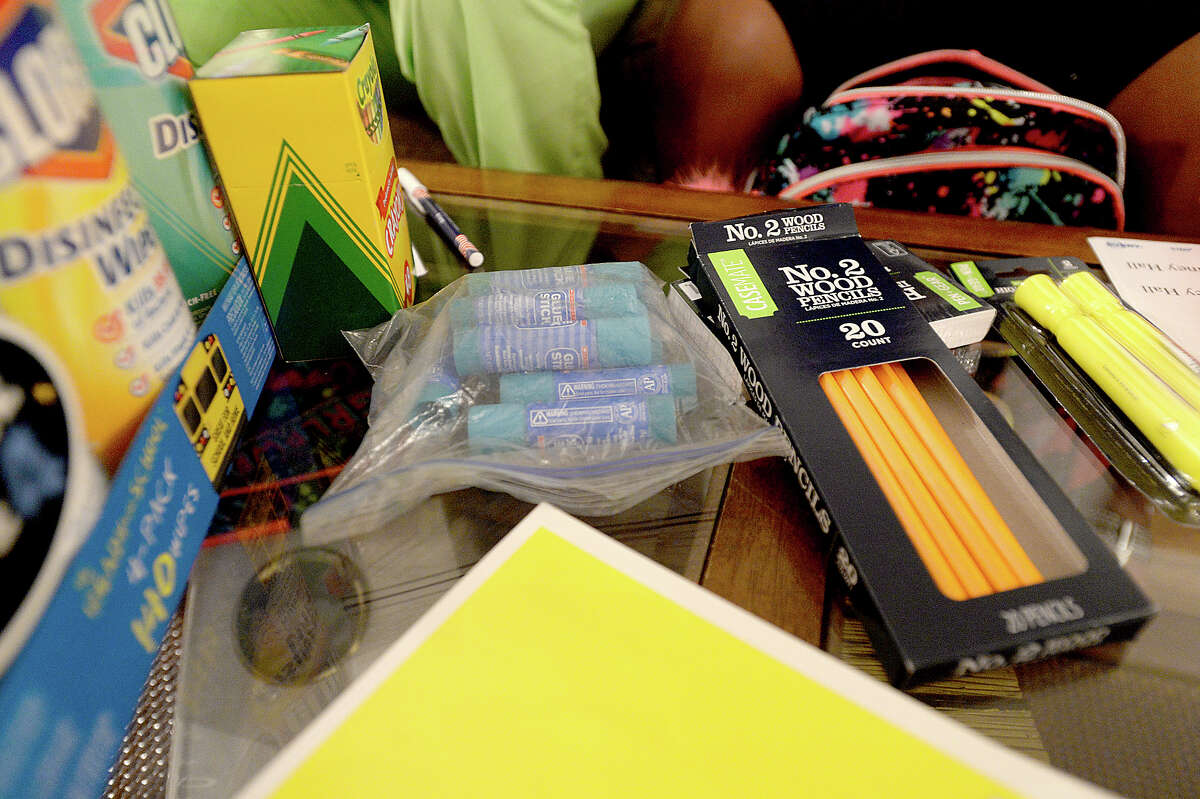 A coffee table is filled with supplies ready for labelling and packing as Shayla Wilcox and her daughter Sydney Hall sort through her school supplies Wednesday. Wilcox says she started early shopping for supplies and sought out coupons and deals to help cut down on costs. In all, there were 24 items on her class-issued supply list. Sydney says she is looking forward to the new school year, especially being with her new teachers. Like many families, they are preparing for the start of a new school year and saying goodbye to the carefree days of summer. Sydney will be a fourth grader this year at Martin Elementary School. Photo taken Wednesday, August 9, 2017 Kim Brent/The Enterprise