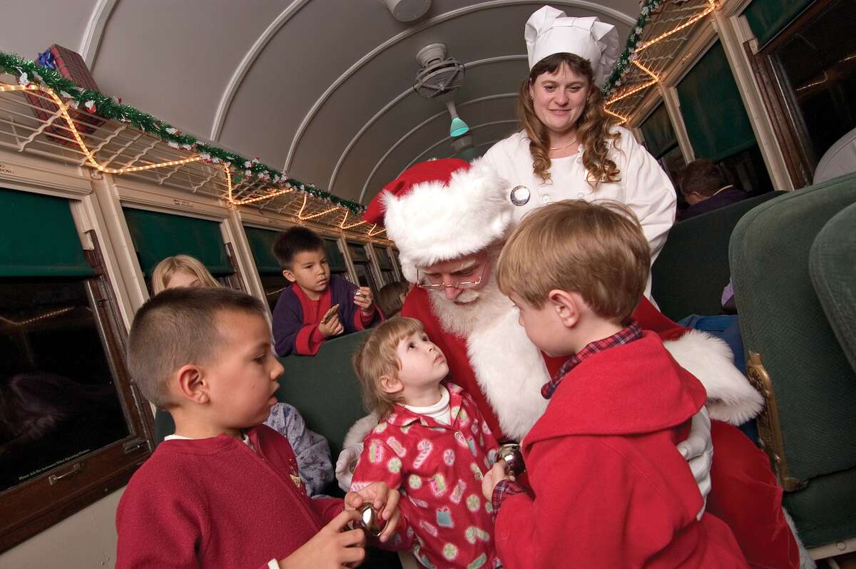 Santa Claus greets passengers aboard the Polar Express.