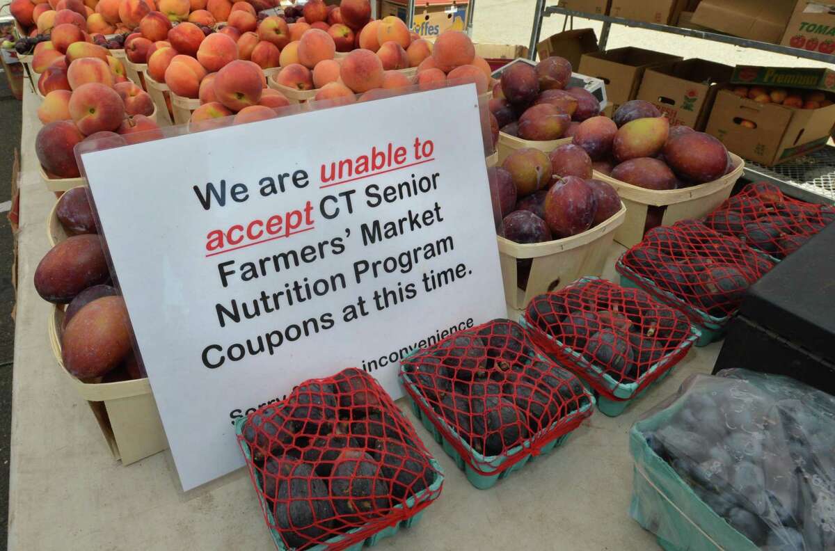 A sign posted at the farmers market at Norwalk Community Helath Center advises customers that certain nutrition coupons from the state of Connecticut are not valid.