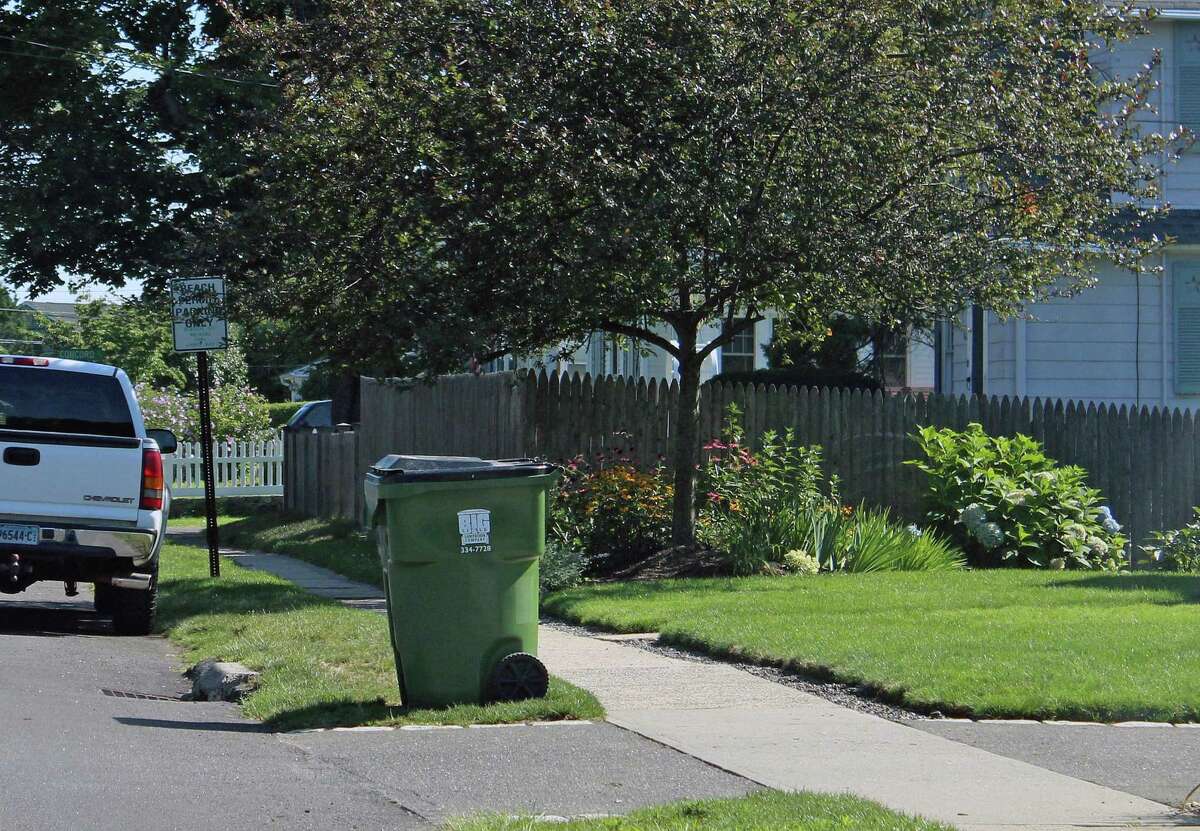 Trash cans brought to the curb to await collection are against town regulations. Curbside collection is only allowed for residential recycling. Fairfield,CT. 8/9/17