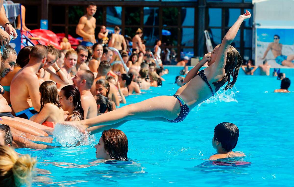 A girl jumps into a public swimming pool in Belgrade on August 5, 2017. Southern Europe and the Balkans are experiencing a heatwave with temperatures reaching more than 40 C (104 F). / AFP PHOTO / PEDJA MILOSAVLJEVICPEDJA MILOSAVLJEVIC/AFP/Getty Images