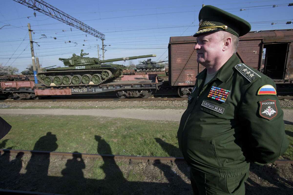 Russian head of Transport Department of the Ministry of Defense Colonel General Igor Lyapin smiles as Russian tanks T-72B, close left, arrive and Ukrainian tanks T-62, center back, are transported to the Ukraine at the Ostryakovo railway station not far from Simferopol, Crimea in 2014. Russia’s annexation of Crimea should still be actively opposed by the U.S.