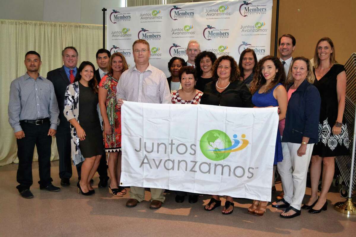 Cos Cob’s Members Credit Union was the first credit union in the state to be recognized as a “Juntos Avanzamos” credit union last week — one which helps underserved Spanish-speaking and immigrant clients. Shown from left are Carlos Castro-Velez, Peter Yeskey, Lesley Ulloa, Harrinson Agudelo-Rios, Kelly Kortner, Brian Wood, Helen Charles, Evelyn Montufar, Michael Gavan, Elsa Soogrim, Kathy Chartier, Lynn Sabatino, Vanessa Kuduk, U.S. Rep. Jim Himes, Linda Shirley and Cathie Mahon.