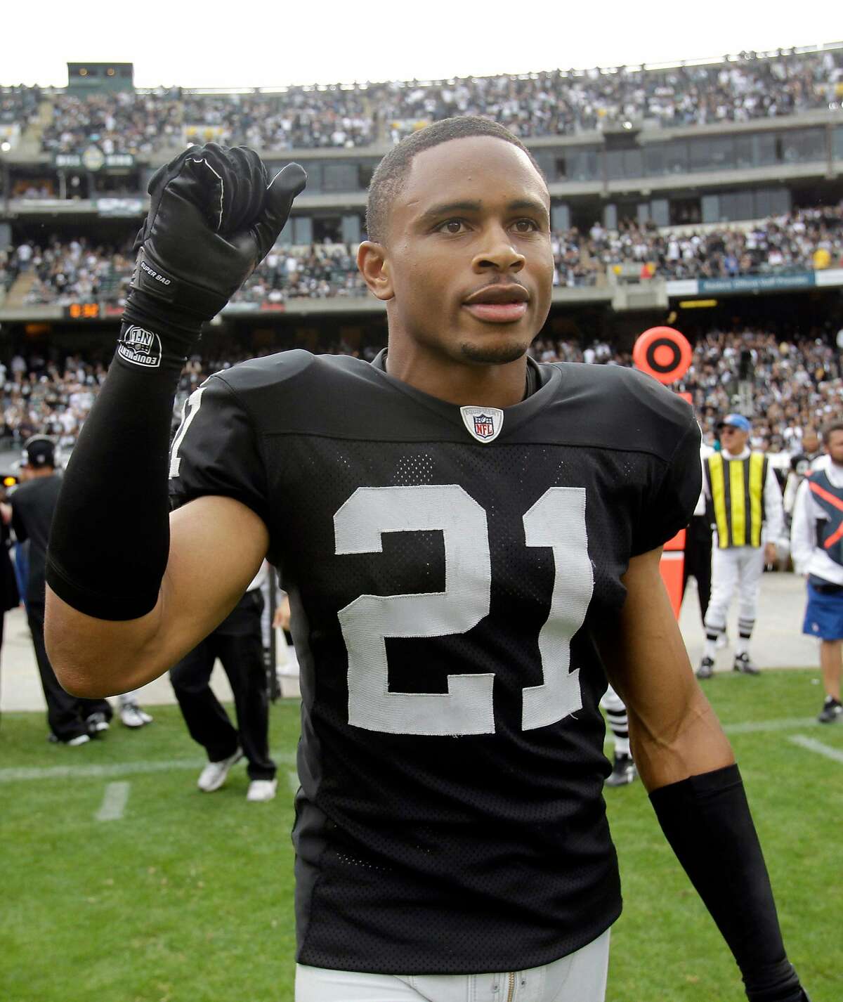 FILE - This Sept. 19, 2010, file photo shows Oakland Raiders cornerback Nnamdi Asomugha (21) at an NFL football game in Oakland, Calif. The challenge: taking more than 1,000 players and sorting them onto 32 rosters, working out contracts that must be signed and then processed by the league office, with every deal from rookies to free agents fitting under the salary cap and falling within the other boundaries of the new, still-being-understood labor agreement _ and, getting all this done in time for the start of the preseason, preferably by the start of training camp. (AP Photo/Paul Sakuma, File)