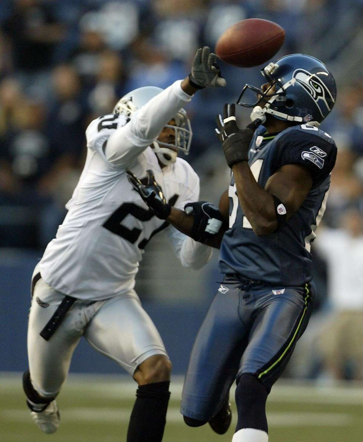 hawks01 Seattle Seahawks Nate Burleson has the ball knocked away by Oakland Raiders Nnamdi Asomugha during first quarter action of exhibition play at Qwest Field in Seattle, Wash., Thursday, August 31, 2006. Photo By Mike Urban Seattle Post-Intelligencer