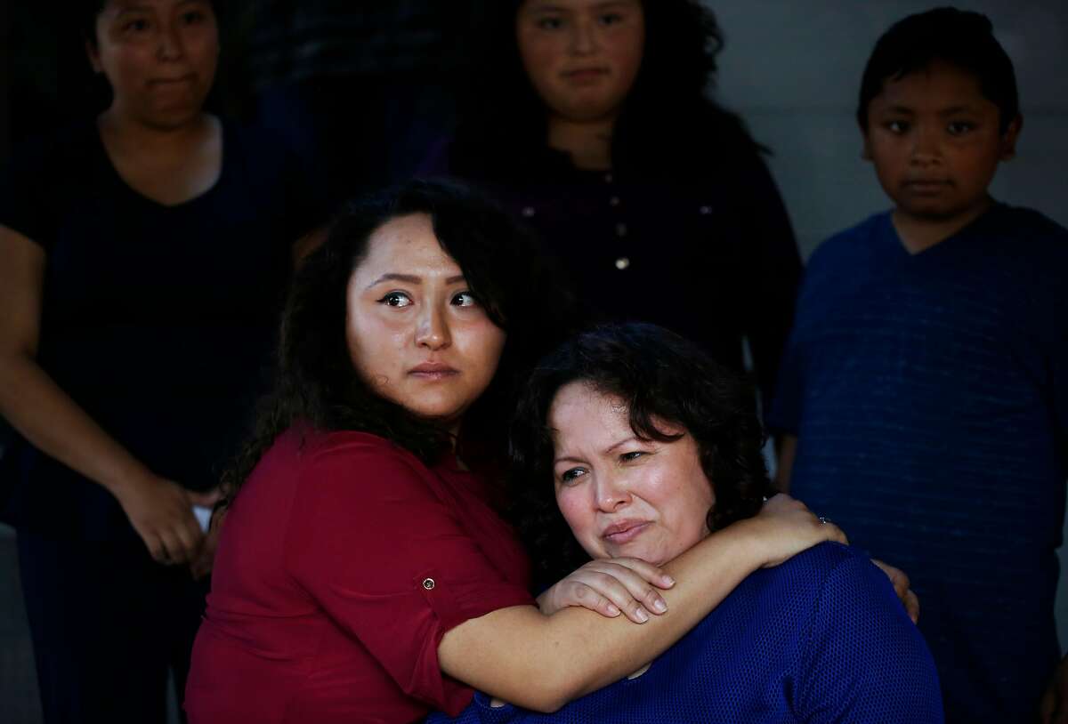 With tears in her eyes, Vianney Sanchez, 23, left, comforts her mother Maria Mendoza Sanchez after a meeting the family had with Sen. Dianne Feinstein at the Sanchez home as siblings, from left, Melin Sanchez, 21, Elizabeth Sanchez, 16, and Jesus Sanchez look on August 10, 2017 in Oakland, Calif.