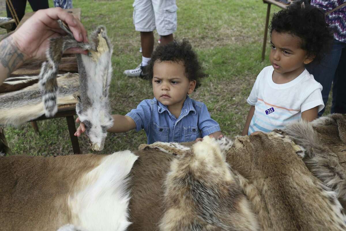 Porter Cervantes (left), 2, and brother Henry, 4, check out a squirrel hide during Buffalo Soldier Day this year at the San Antonio Institute of Texan Cultures. A reader describes the value of the institute.