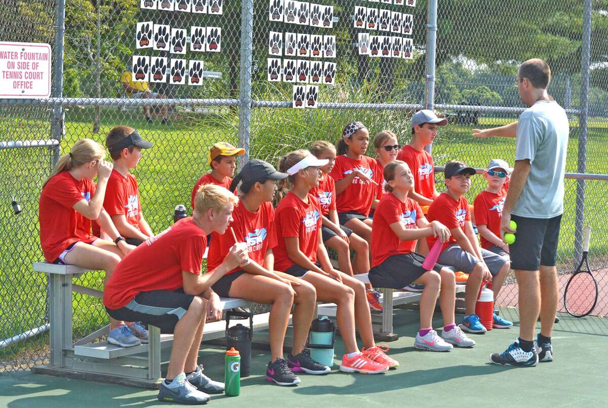 Kirk Schlueter, far right, gives instructions to the ball kids for the USTA Edwardsville Futures tournament, which will run through Sunday at the EHS Tennis Center.
