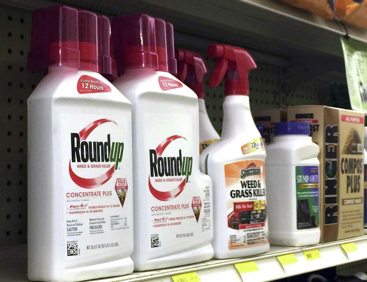 In this Thursday, Jan. 26, 2017, photo, containers of Roundup, left, a weed killer is seen on a shelf with other products for sale at a hardware store in Los Angeles. Glyphosate, the active ingredient in Roundup, is a suspected carcinogen. As the federal government renews tests to determine how much glyphosate is in America’s foods, Connecticut environmental groups, organic farmers and a U.S. senator say it’s time to limit the use of, or ban, the popular herbicide. (AP Photo/Reed Saxon)