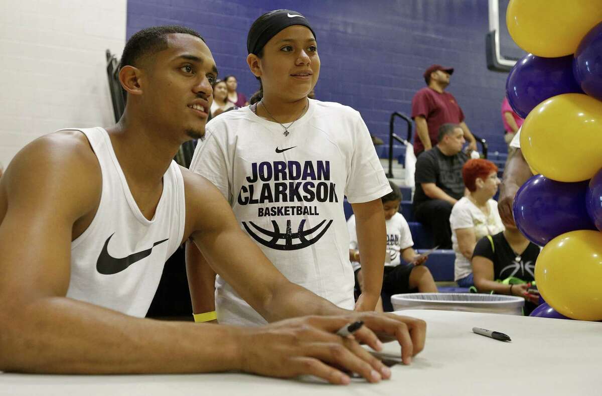 Los Angeles Lakers’ Jordan Clarkson poses for a photo with Addison Rojas, 11, during a dual basketball clinic with the Oklahoma City Thunder’s Andre Roberson (not pictured) on Aug. 4, 2017 at Veterans Memorial High School in San Antonio.
