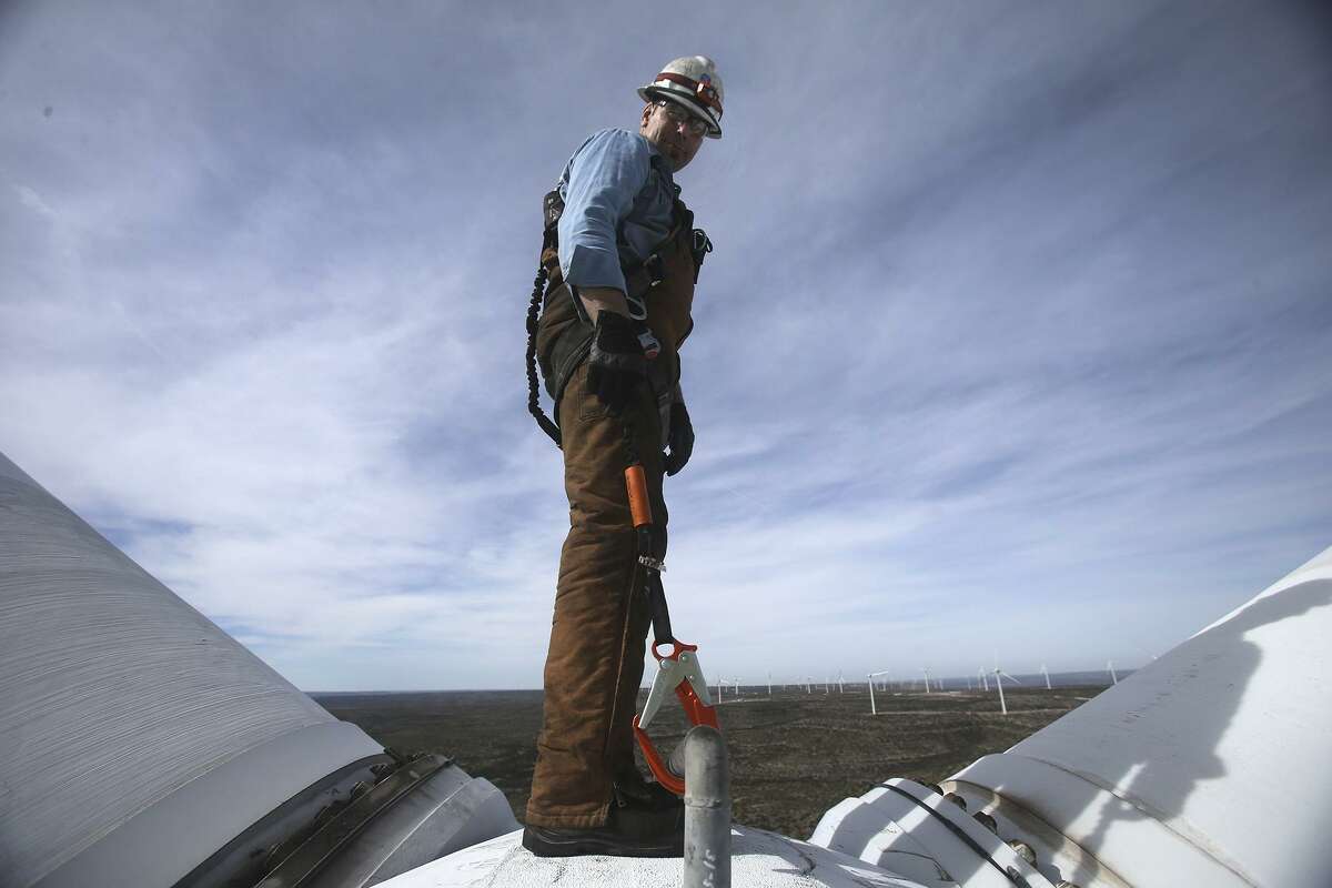 Randy Adams hangs off the hub of a prop of a wind turbine at the Desert Sky Wind Farm Jan. 10, 2017, hundreds of feet above the West Texas plains near Iraan, Texas. Adams was performing maintenance on one of the many aging wind turbines that supply power to CPS Energy.