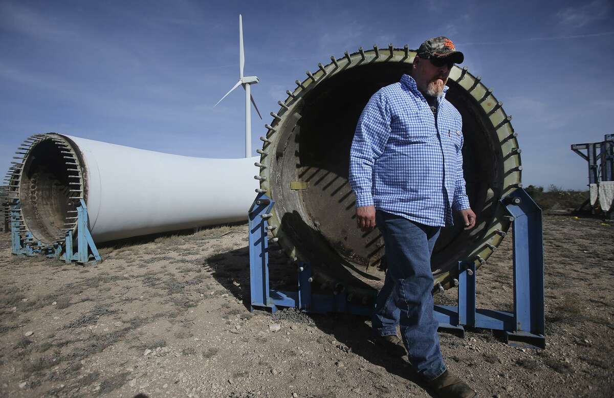 Jay Oliver, Operations Manager at Desert Sky Wind Farm near Iraan, walks past giant blades used for wind turbines. These blades were being stored for salvage. The skin of the blades are made from fiberglass.